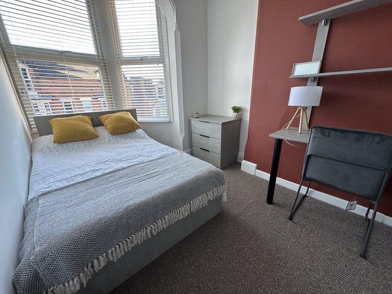 Bright and cozy double bedroom featuring a comf...