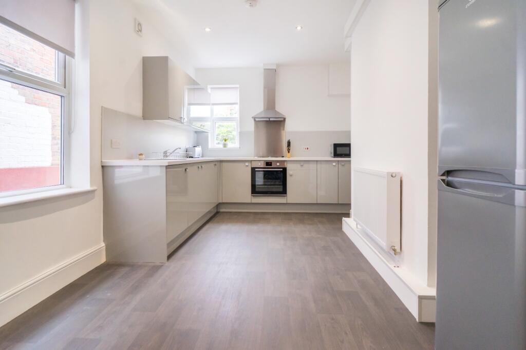 Bright and modern kitchen featuring ample count...