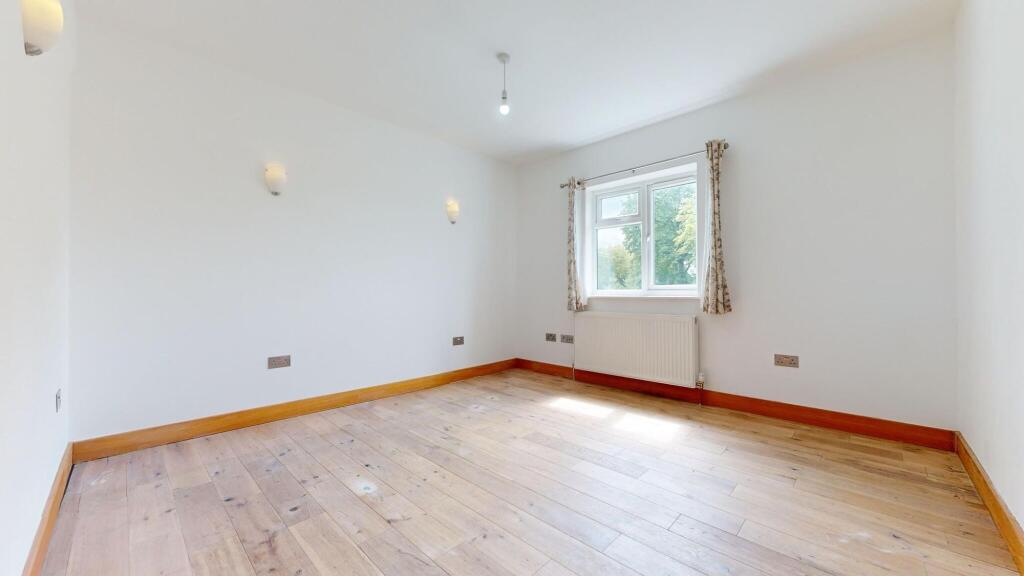 Bright and welcoming bedroom with a large windo...