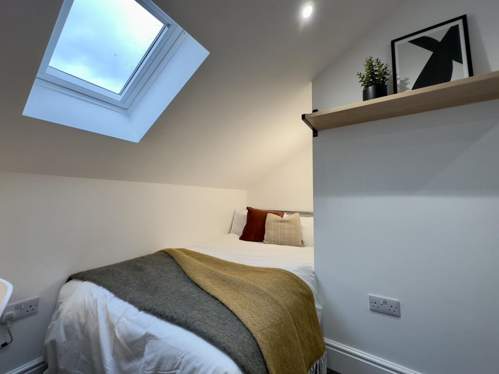 A bright and cozy double bedroom featuring styl...