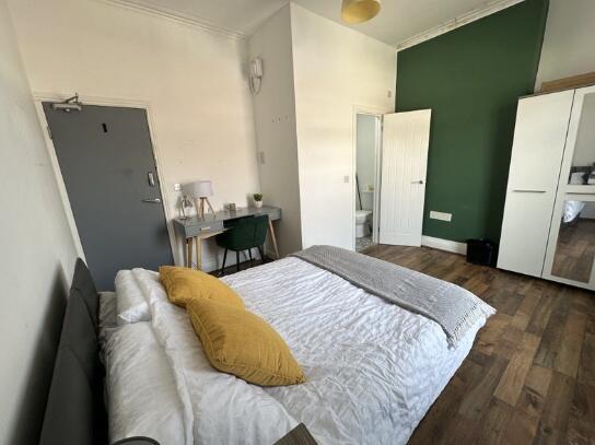 Bright and stylish master bedroom featuring a c...