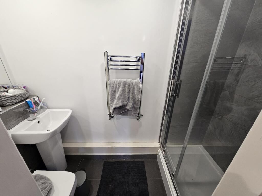 A clean and well-maintained bathroom with a sho...