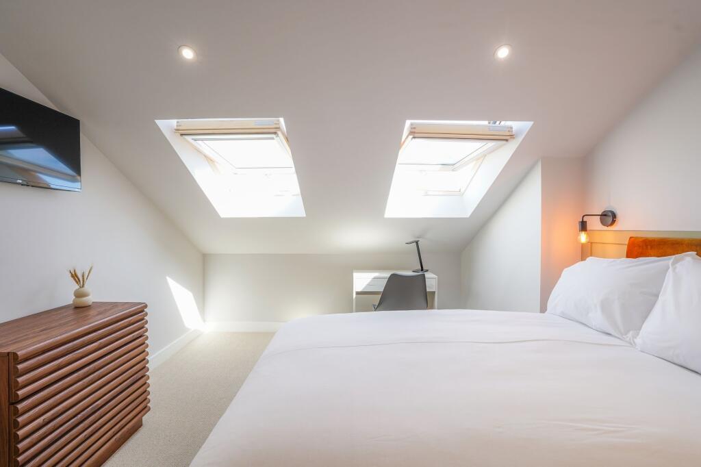 Bright and welcoming master bedroom featuring n...