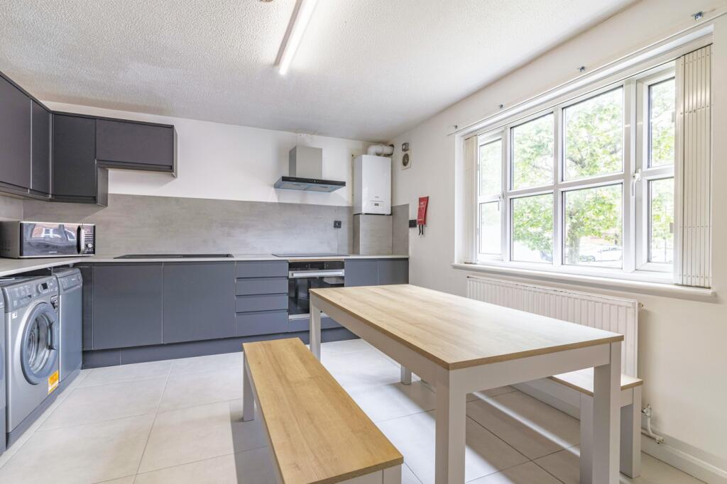 A modern kitchen featuring ample counter space ...