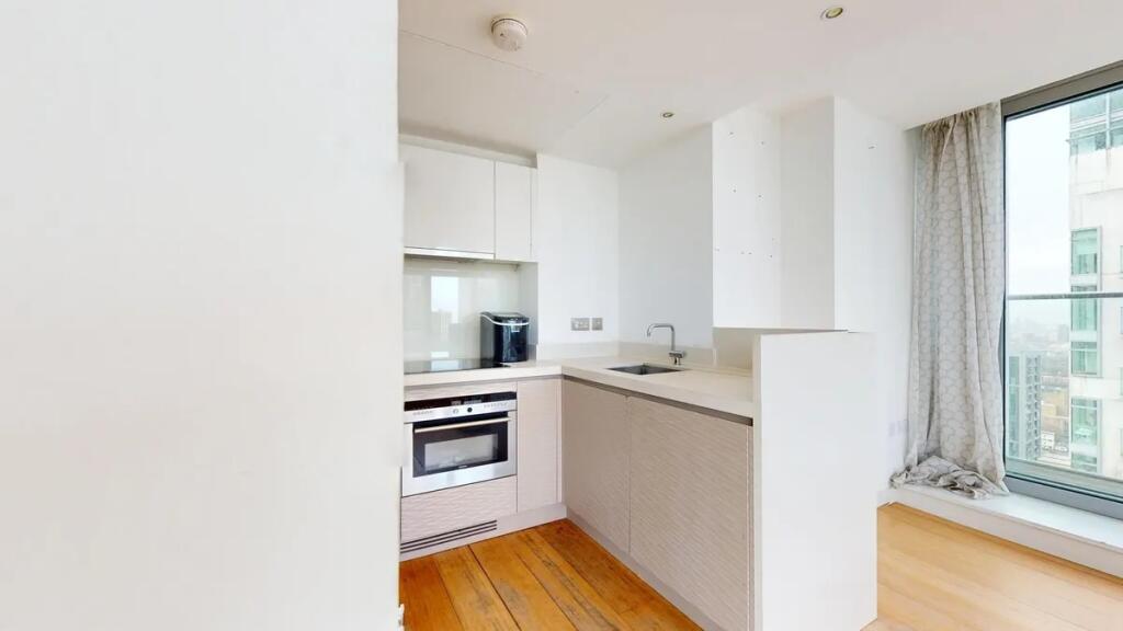 Bright and modern kitchen featuring sleek cabin...