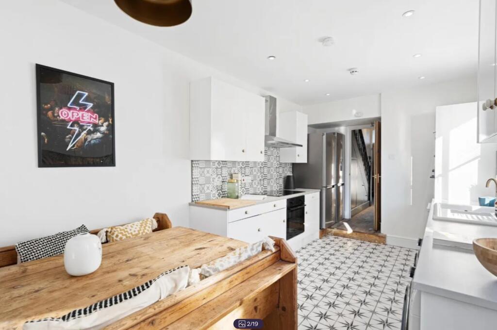 A bright and modern kitchen featuring stylish d...