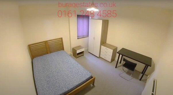 A simple, tidy bedroom with a double bed frame ...