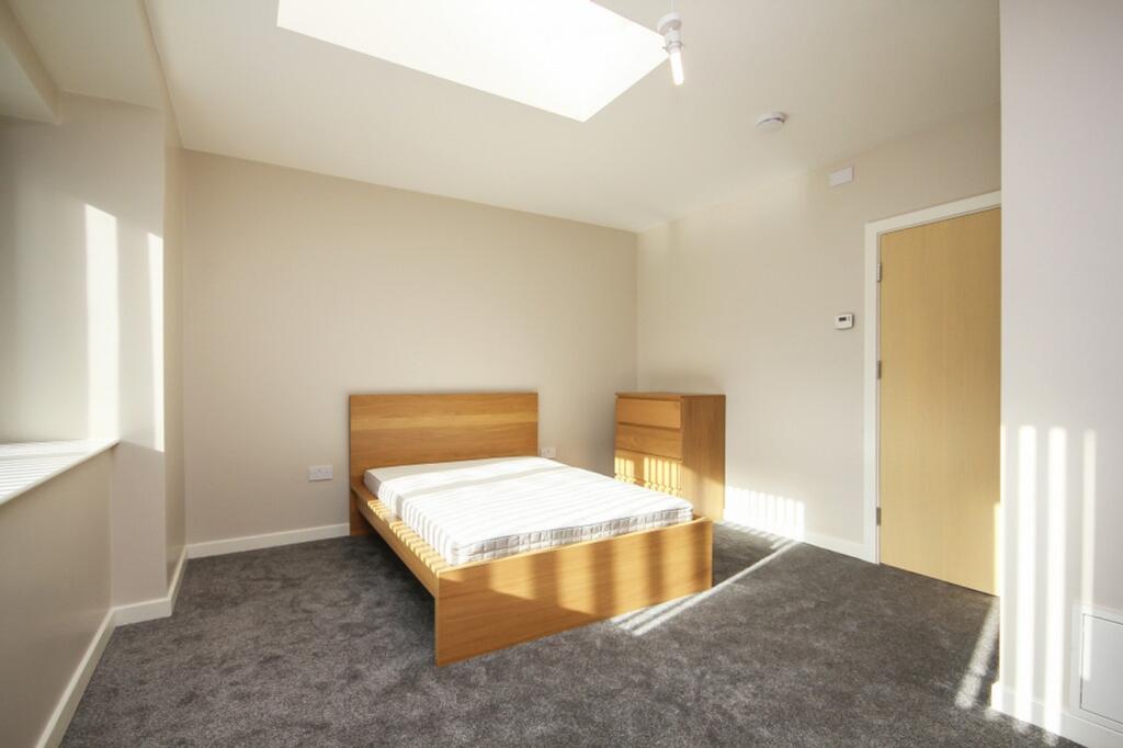 A bright and spacious double bedroom featuring ...