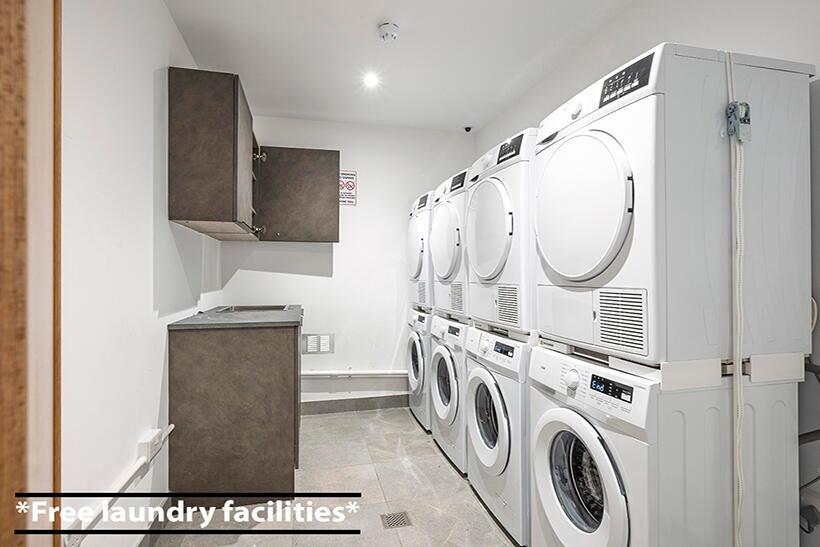 A clean and well-organized laundry room featuri...