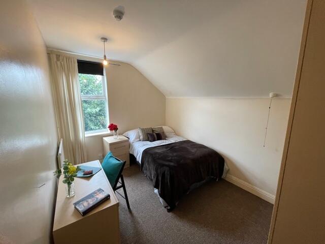 A cozy double bedroom with natural light stream...