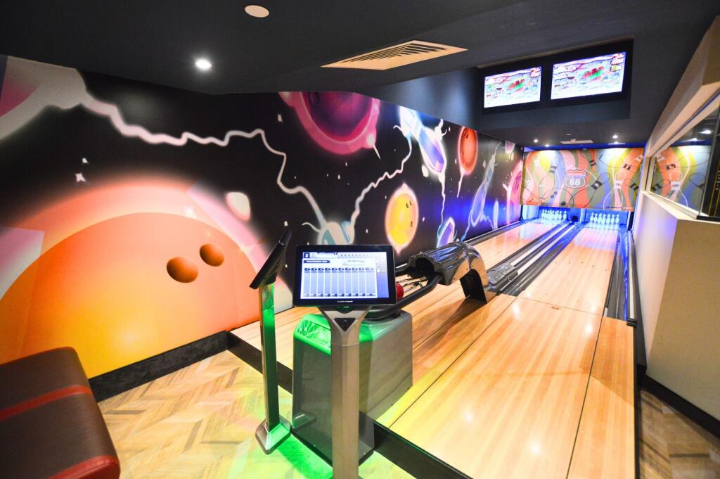 A modern bowling alley room with vibrant space-...