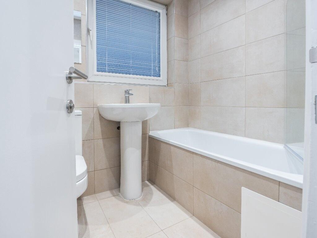 A clean and modern bathroom suite featuring a f...