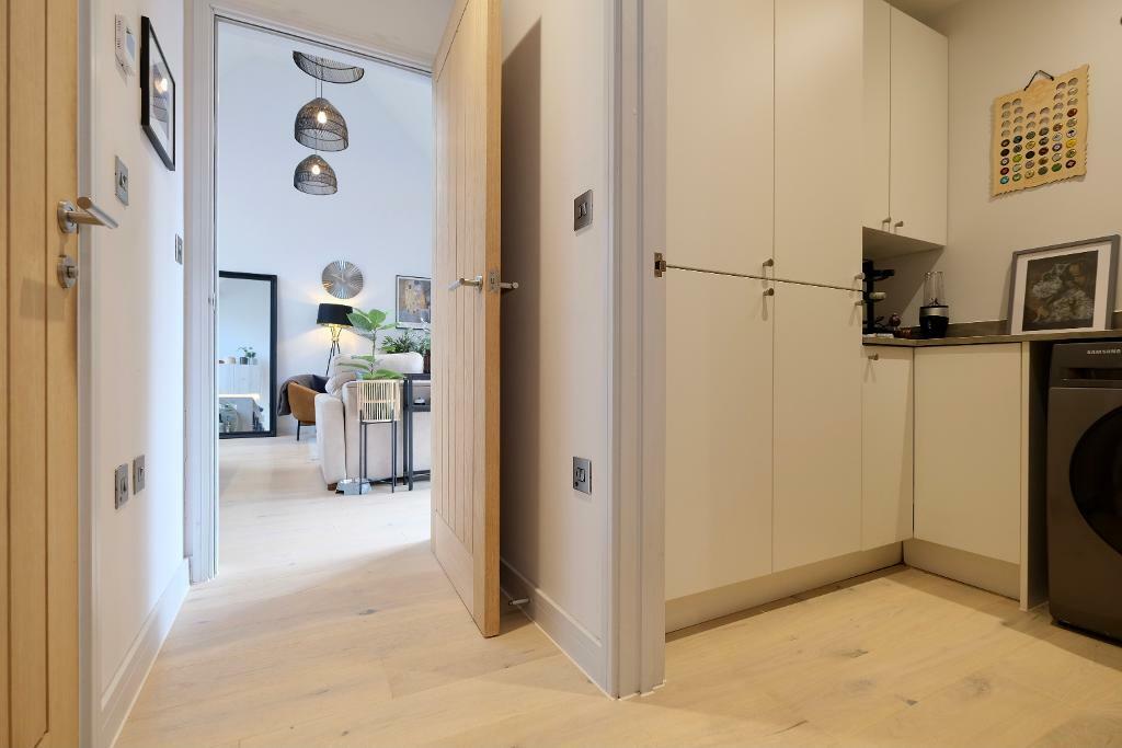 Utility room with fitted cupboards