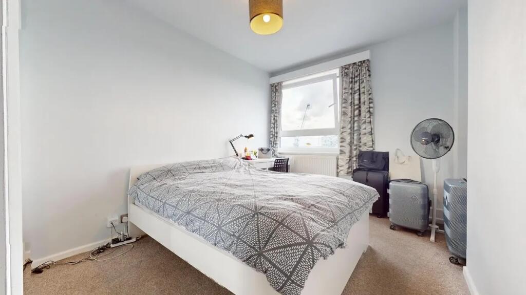 Bright and neat double bedroom featuring a comf...