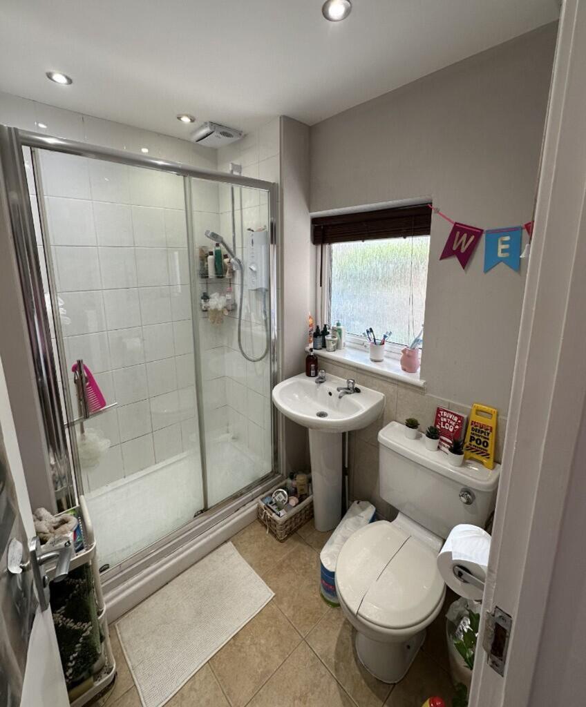 A modern bathroom featuring a spacious walk-in ...