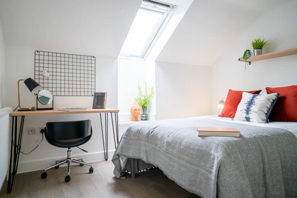 A bright and inviting double bedroom featuring ...