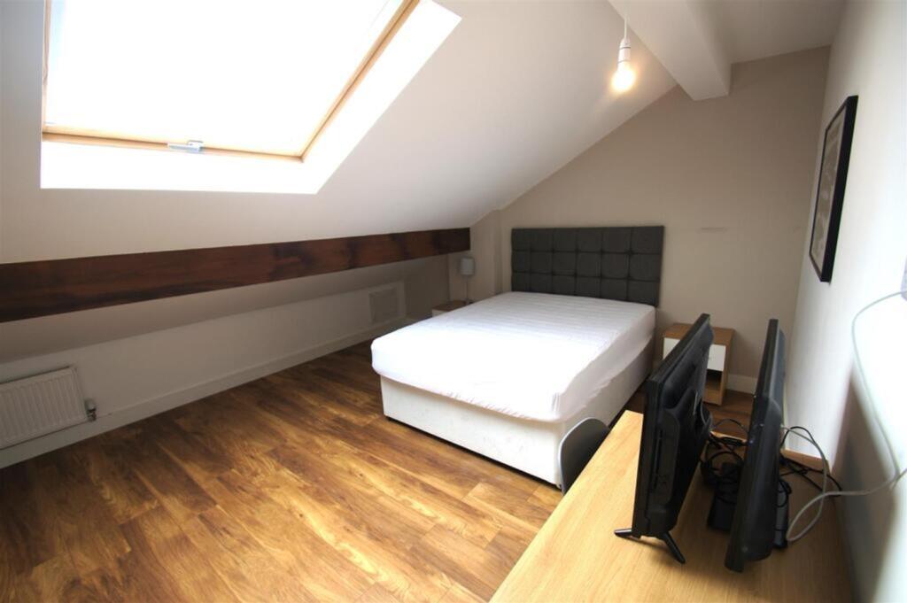 Spacious double bedroom featuring a comfortable...