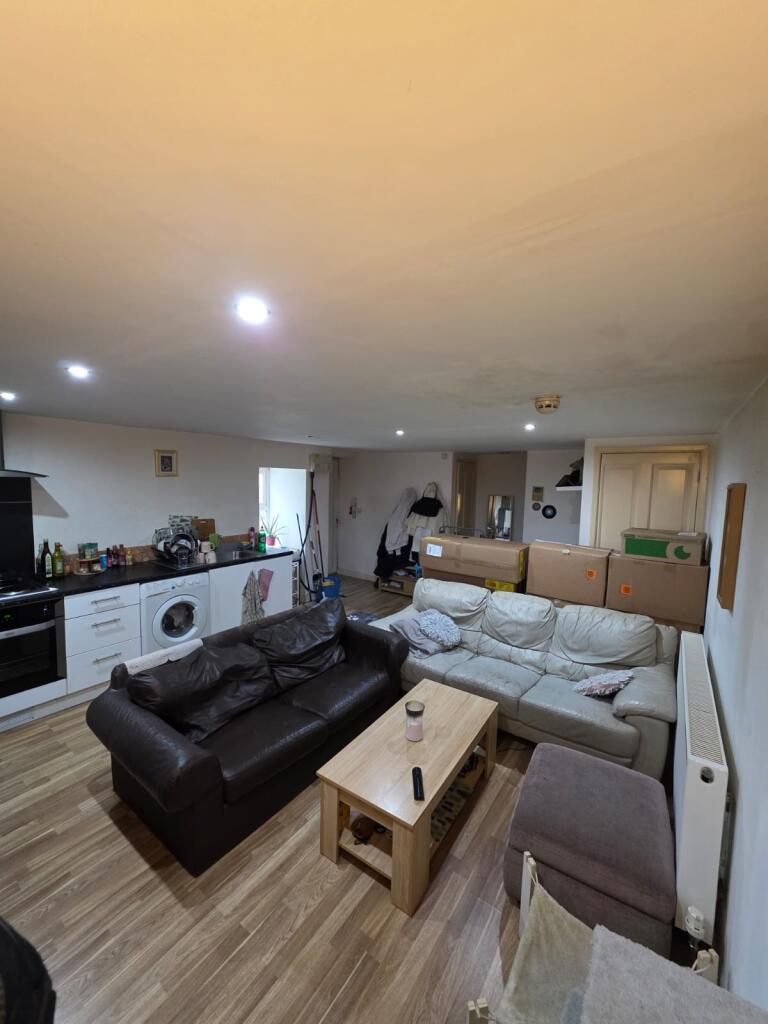 Open-plan living area with two comfortable sofa...
