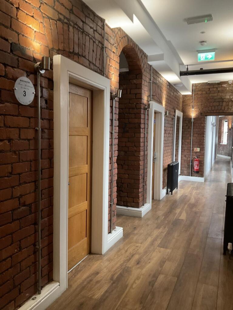 A well-maintained hallway featuring exposed bri...