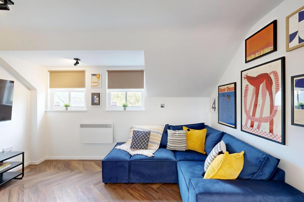 Bright, modern living room with a comfortable b...