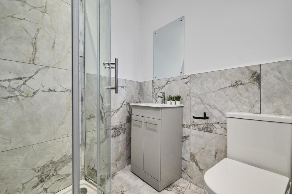 Modern bathroom featuring a large shower enclos...