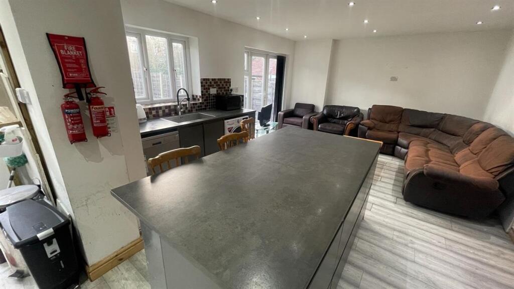 Bright open-plan living area with a large centr...