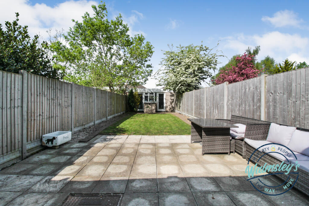 Rear patio &amp; gardens with double garage at far end
