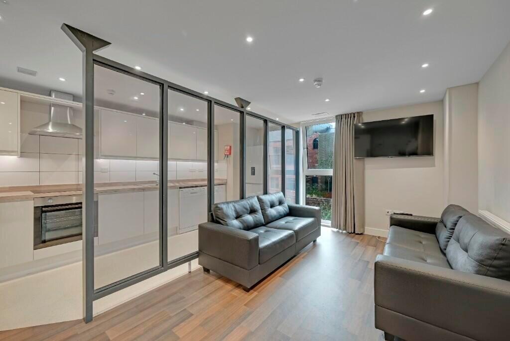 A modern living room with comfortable black lea...