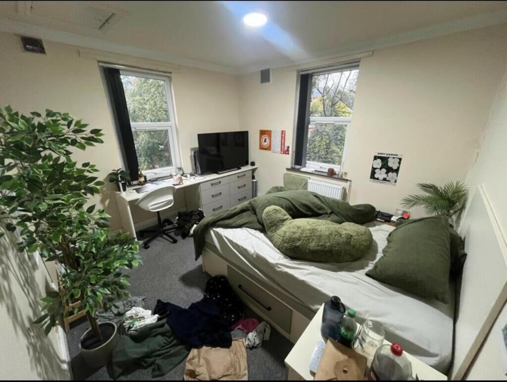 Bright and spacious living room with large wind...