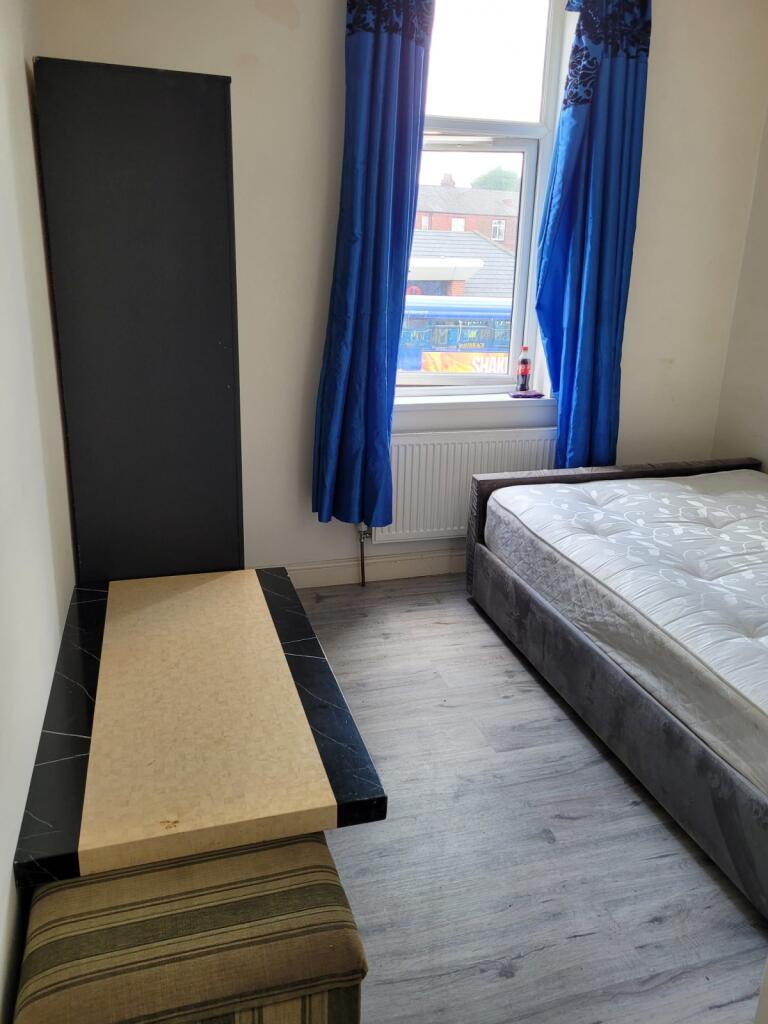 A neat and functional double bedroom featuring ...