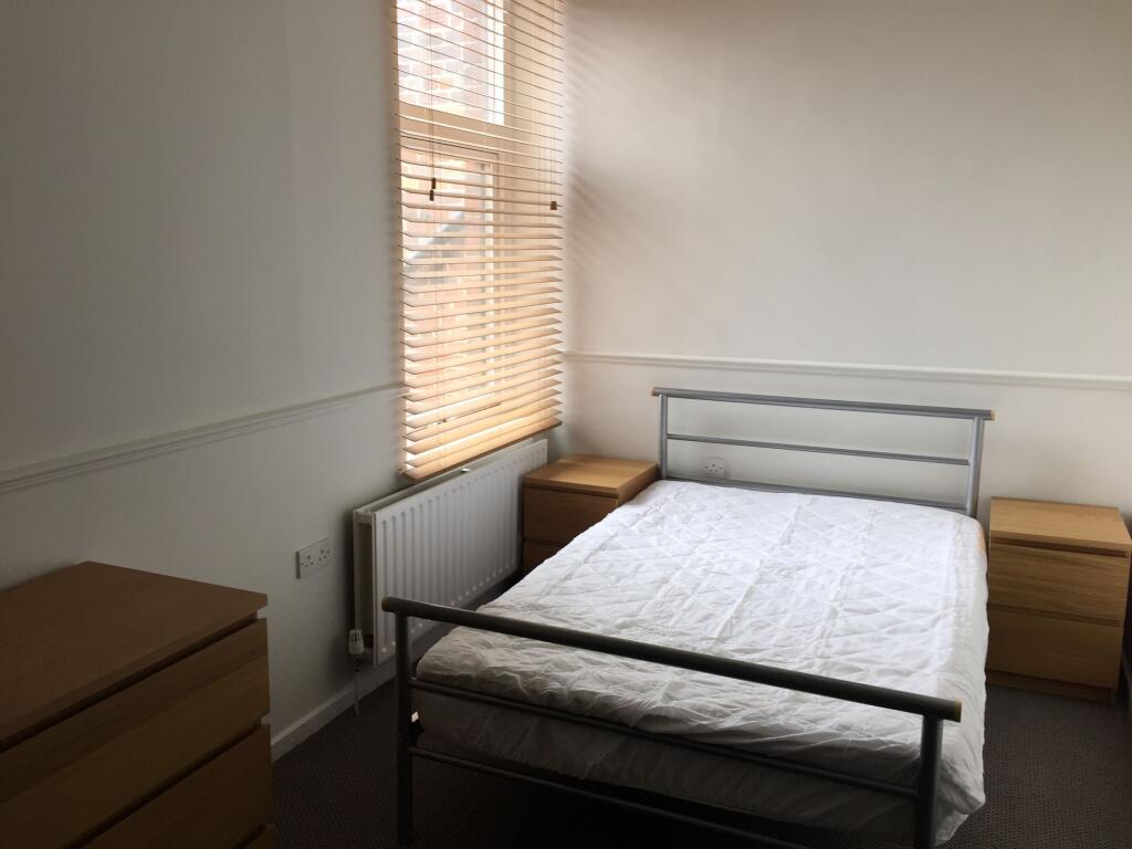 A bright, clean double bedroom featuring a mini...