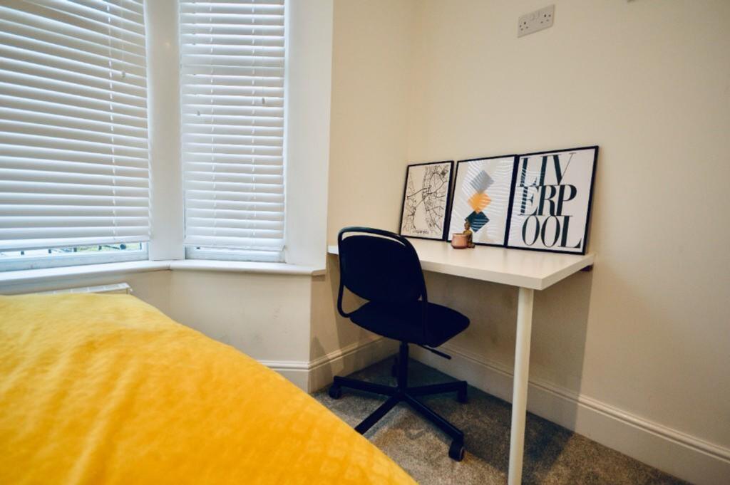 A cozy and inviting double bedroom with a study...