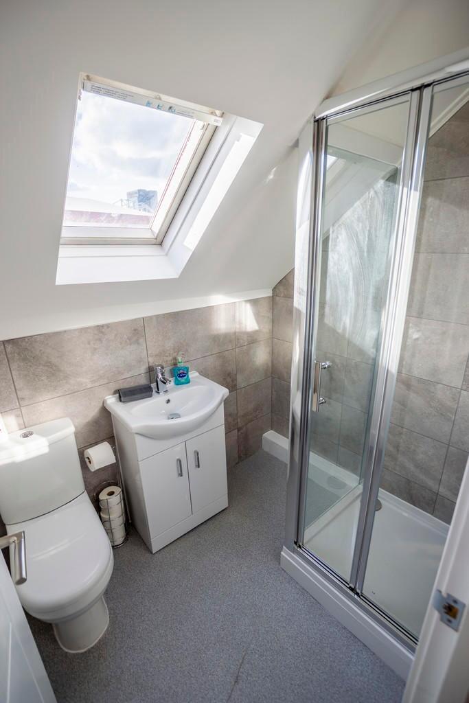 Bright and modern bathroom featuring a spacious...