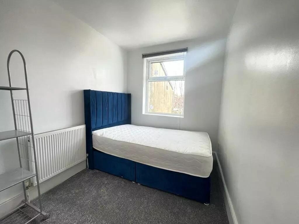 A neat and bright single bedroom featuring a co...