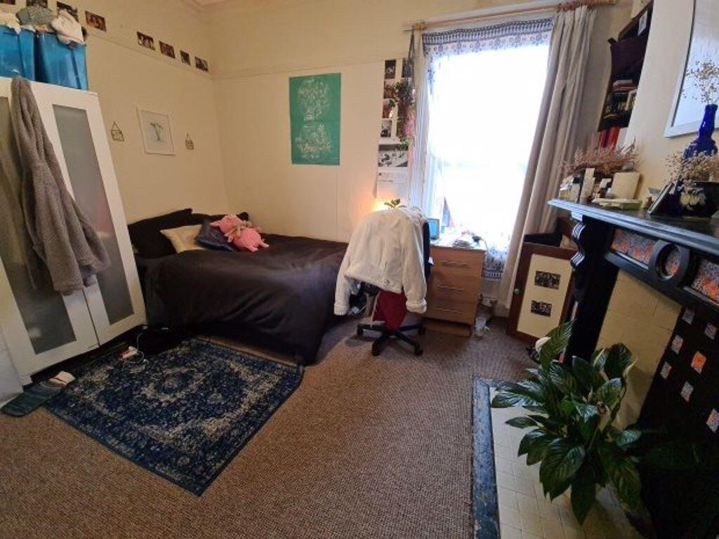 A cozy bedroom featuring a double bed, a wardro...