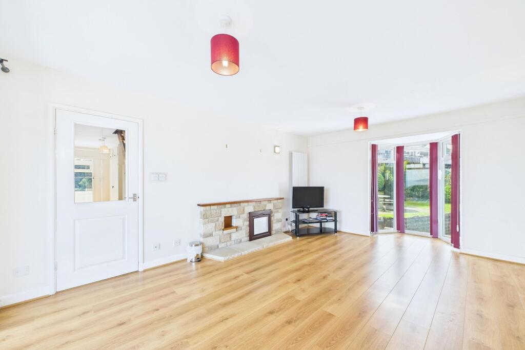 Living room with a walk-in bay window overlooking 
