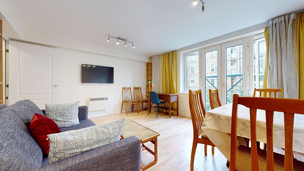Bright and spacious living area featuring large...
