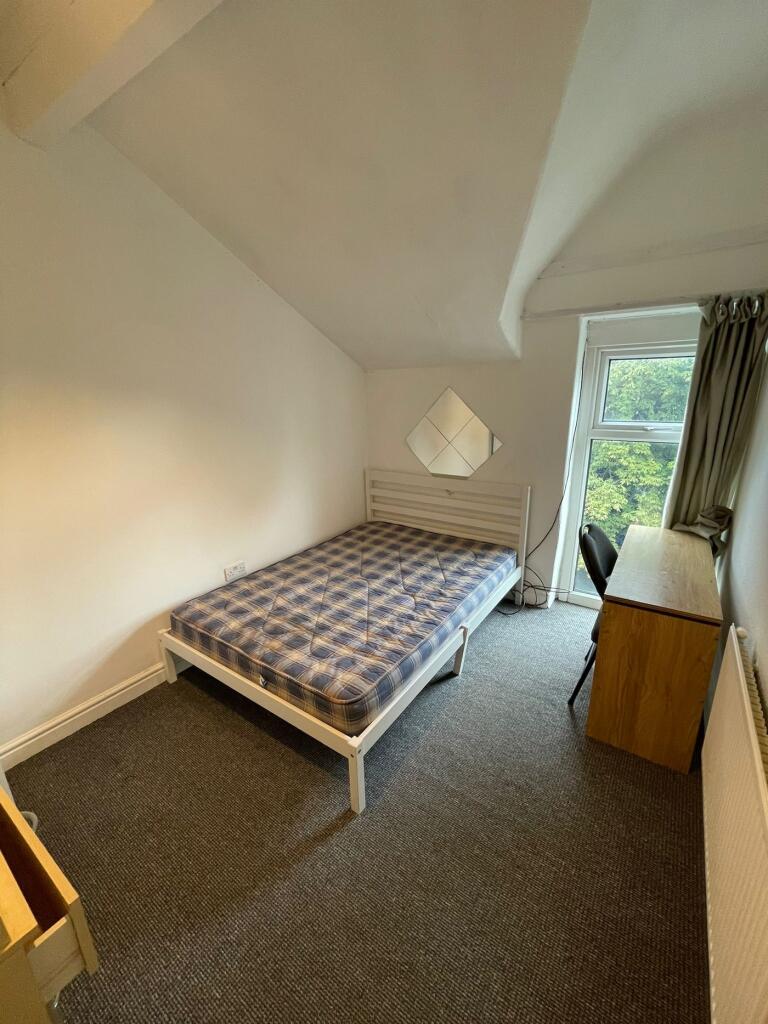 A bright and inviting double bedroom with ample...