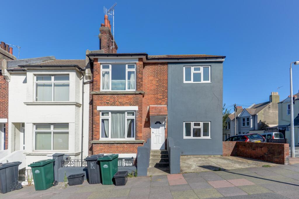 A well-maintained terraced house front with a b...