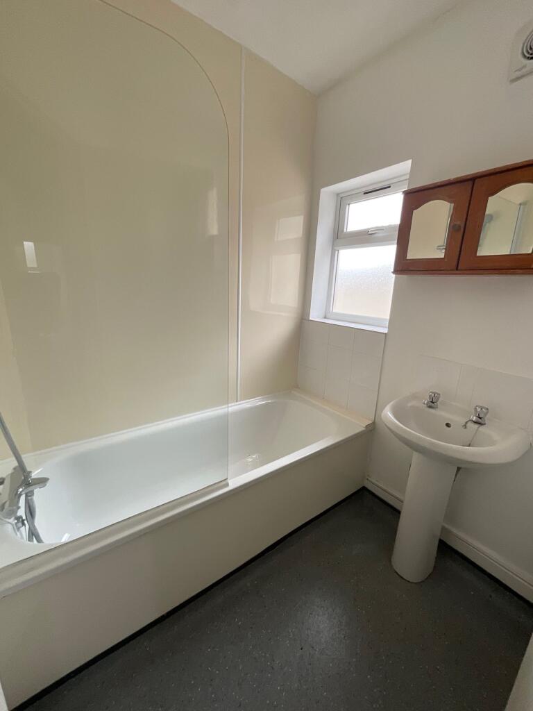 Bright and clean bathroom suite featuring a spa...