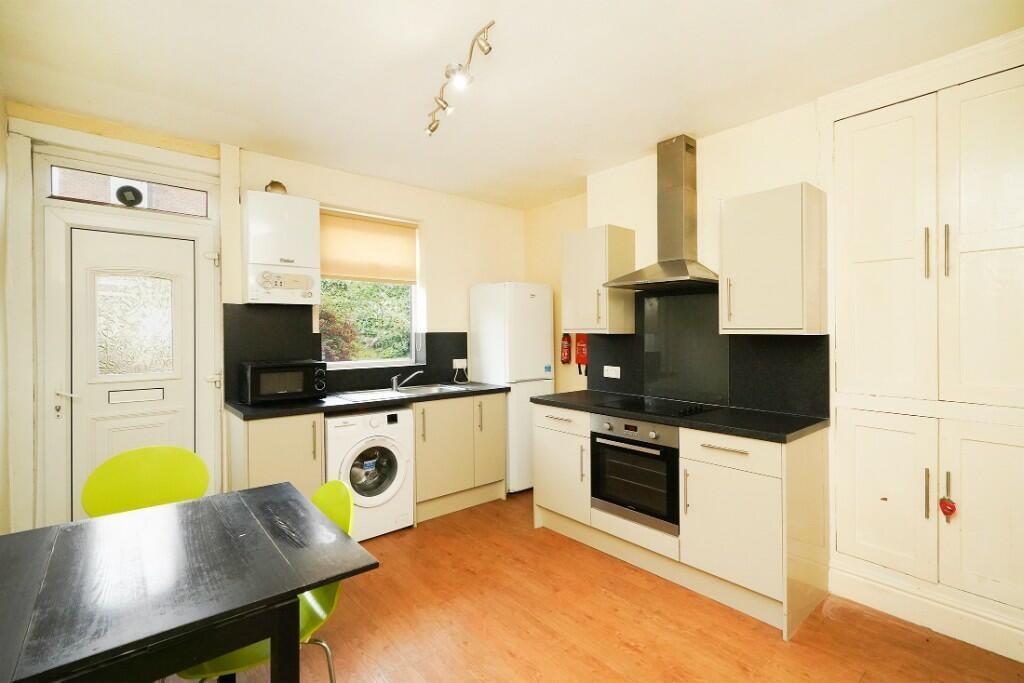Bright and clean kitchen featuring modern cabin...