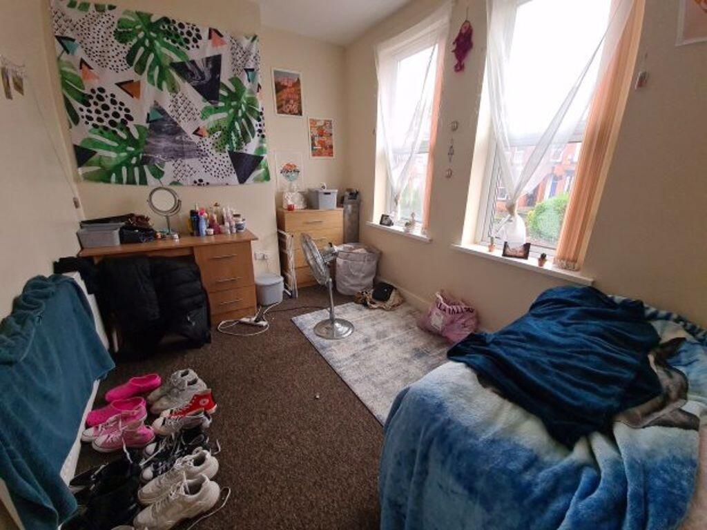 Cozy bedroom with two large windows letting in ...