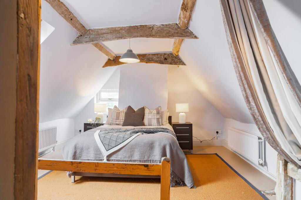 Attic bedroom with velux window and exposed beams
