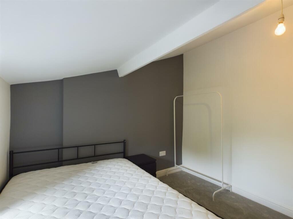 A cozy and inviting double bedroom with a minim...