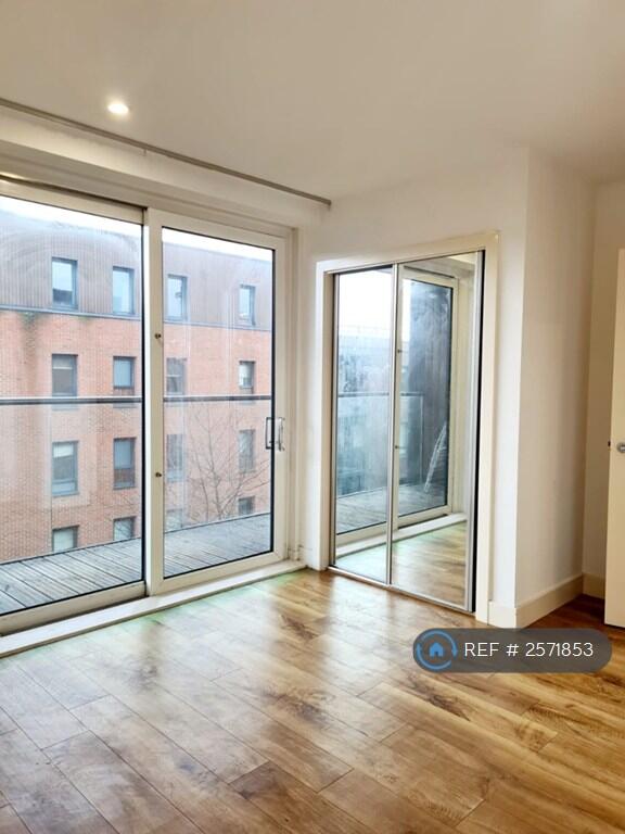 Master Bedroom With Floor To Celing Balcony Doors