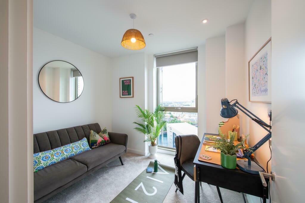 Bright and modern communal workspace featuring ...