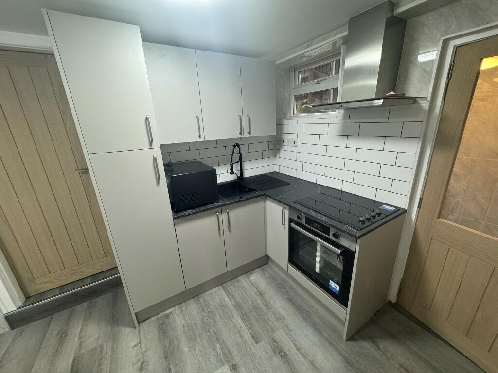 Modern kitchen featuring stylish white cabinets...