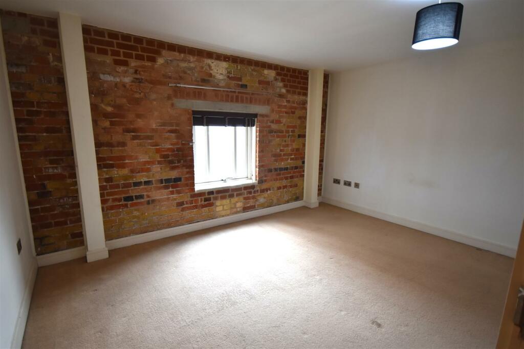 Master bedroom brick wall.JPG