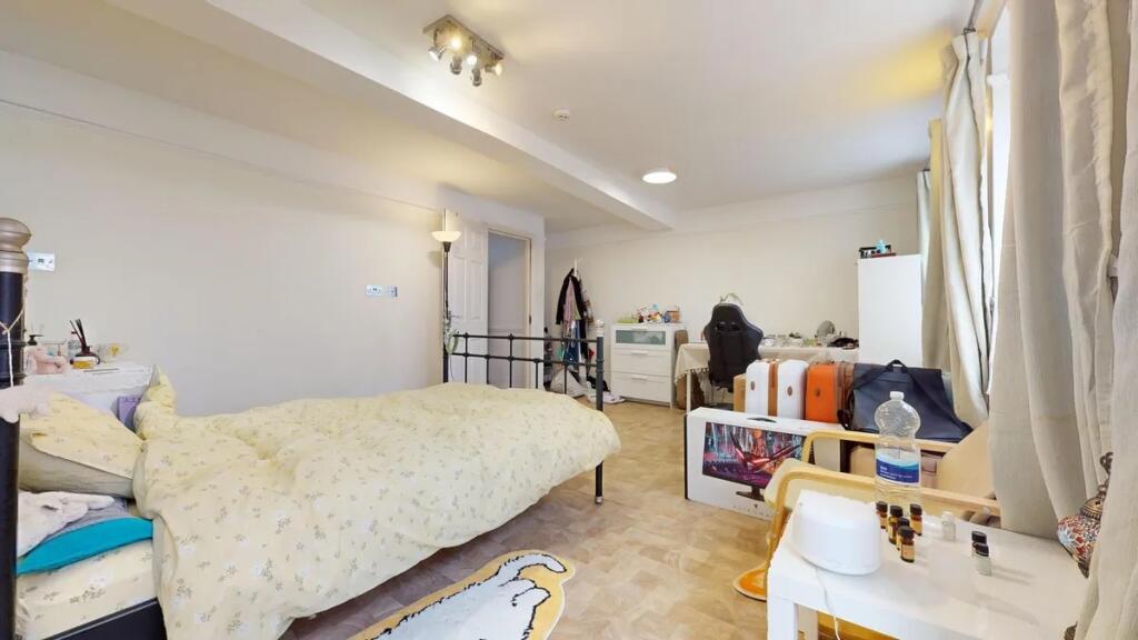 Bright and spacious master bedroom featuring a ...