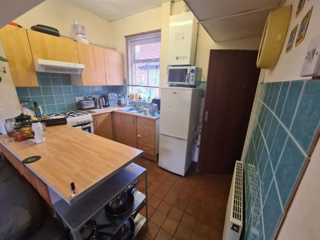 A practical kitchen featuring a compact layout ...